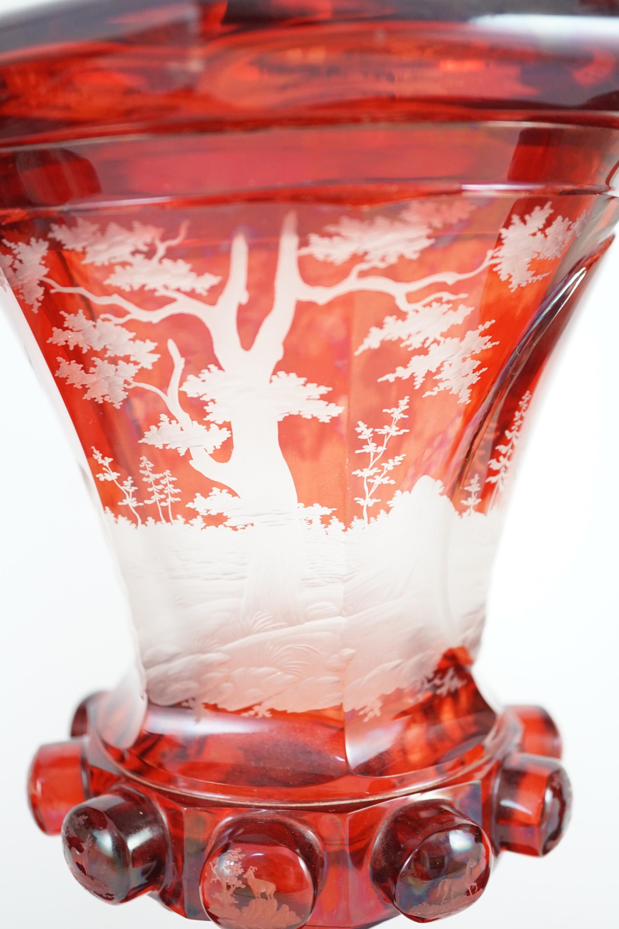 Three large Bohemian ruby stained glass goblets and covers, late 19th century, 38.5cm to 50.5cm high, rim chips